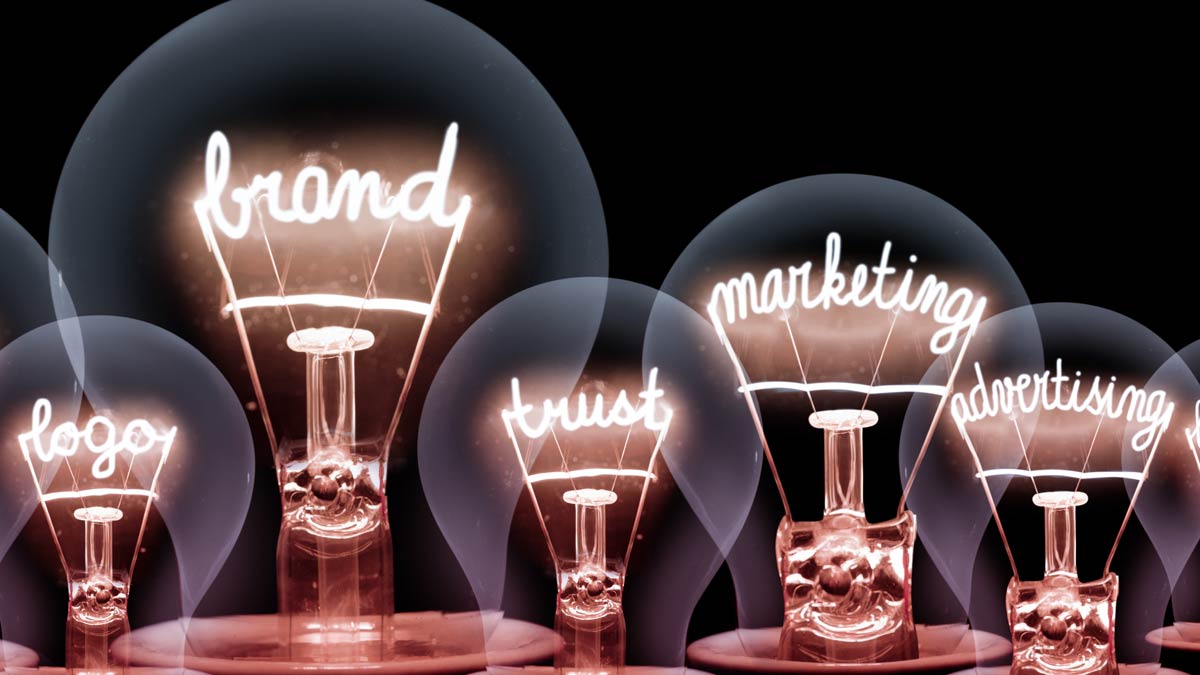 clear lightbulbs with the words "brand," "marketing" and "trust" illuminated inside